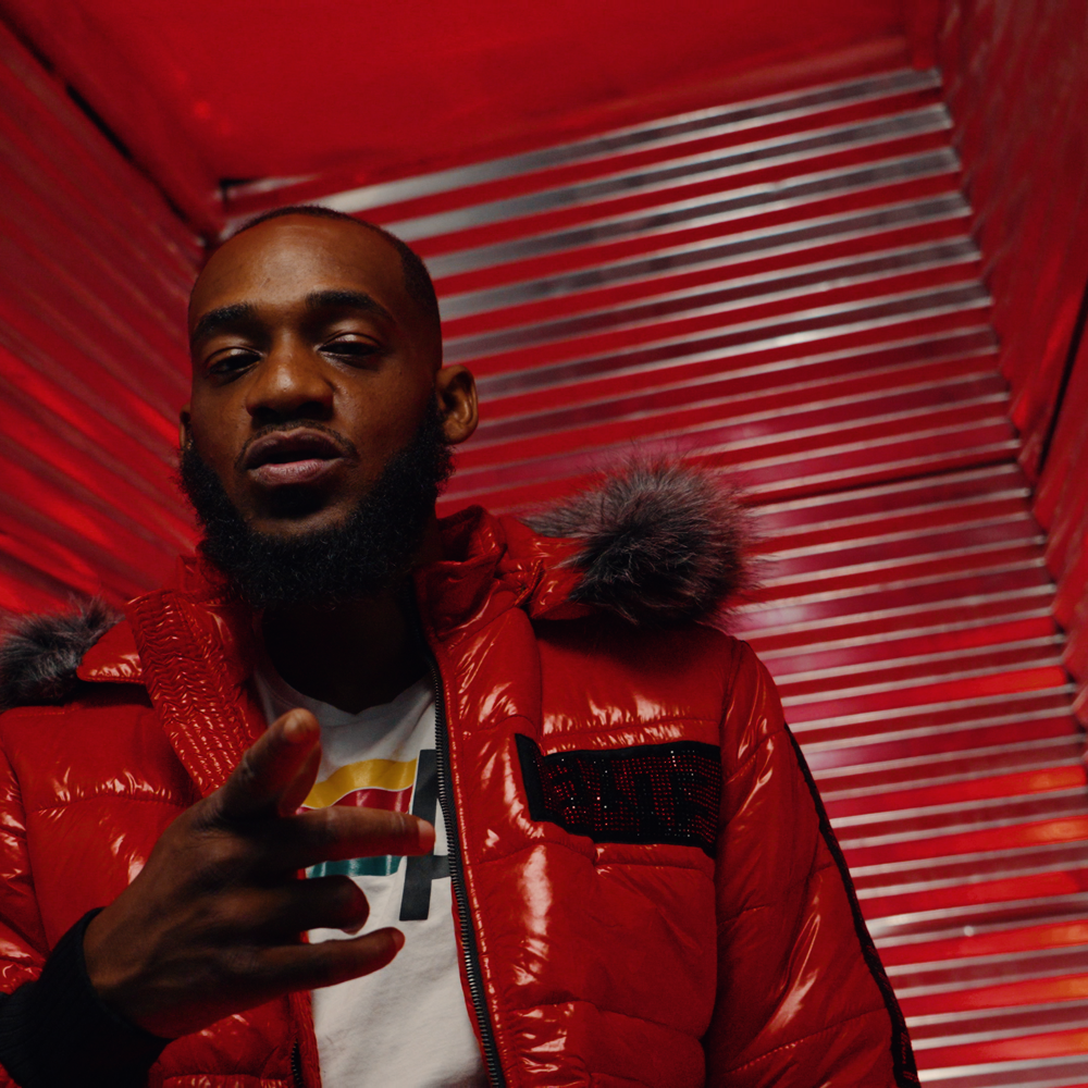 QVVDIER in a red jacket, official artist portrait